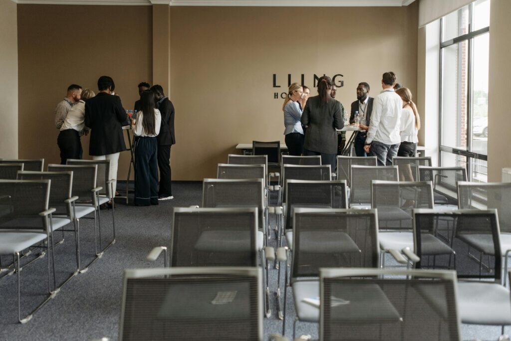 A group discussion taking place in a contemporary conference room with empty chairs.